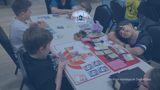 Family playing tabletop games and card games around a table for screen-free game night